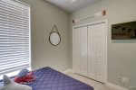 Downstairs bunk room has ample closet storage and a wall mounted smart TV